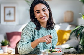 Smiling woman eating a healthy meal