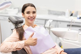 Dental patient making thumbs up gesture