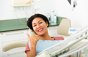 Dental patient making thumbs up gesture