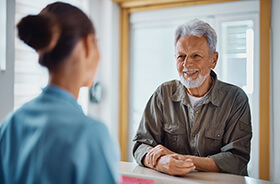 Dental patient talking to front desk team member