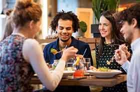 Young adult friends enjoying a meal together