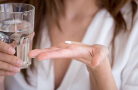 Woman preparing to swallow a sedative pill